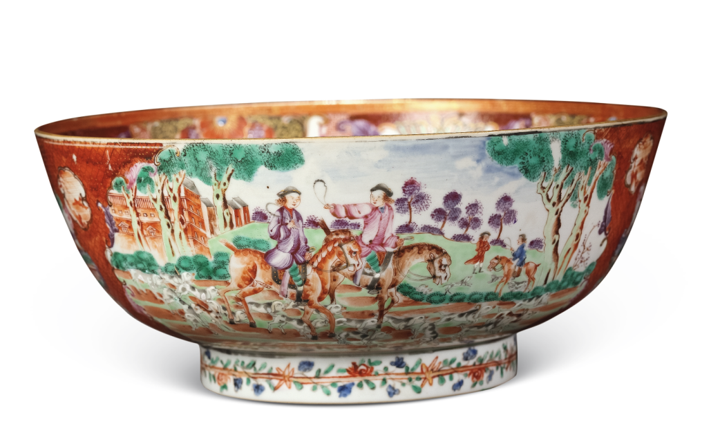 圖為清乾隆廣彩錦地開光洋人狩獵圖潘趣碗。外壁以錦地紋作地,對(duì)稱開光繪兩幅洋人狩獵圖,另開兩窗繪中式庭院人物圖,圈足飾花卉紋一周。(來源:廣州十三行博物館)